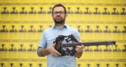 Credit: Chris Hind Pedro Reyes posing with one of his gun sculptures